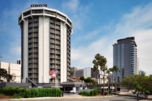 a tall white building with a hotel sign on it at The DEXTRO Little Italy, BW Premier Collection in San Diego