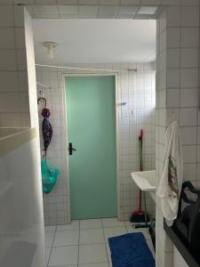a bathroom with a blue door and a sink at Apartamento em Camboinha PB in Cabedelo +16 photos