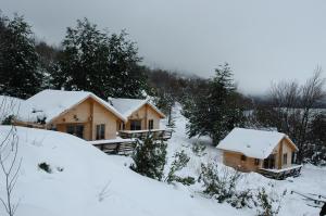 a log cabin in the snow with snow at Vista Hermosa Conguillio in Conguillío +23 photos