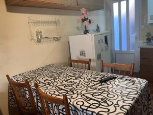 a kitchen with a table and a refrigerator at Departamento céntrico - Cerca de la playa in Monte Hermoso +2 photos