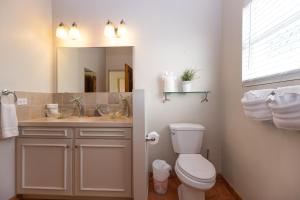 a bathroom with a toilet and a sink and a mirror at The Breeze in St Thomas +75 photos