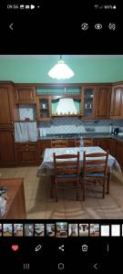 a rendering of a kitchen with a table and two benches at Casa con giardino in Cecina