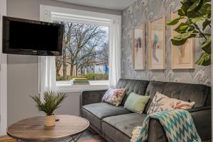 a living room with a couch and a window at Downtown Vista - 5 mins to Water - Pet in Cornwall