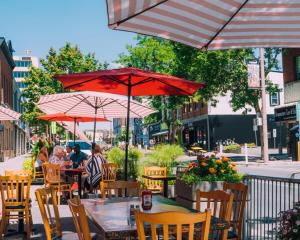 a group of people sitting at a table under umbrellas at Downtown Vista - 5 mins to Water - Pet in Cornwall