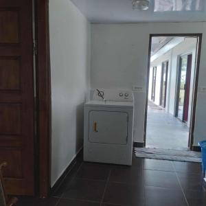 a room with a small stove and a mirror at Sidonie parker in Teahupoo