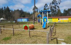 un parc avec une aire de jeux avec un toboggan dans l'établissement Casa Nature's Avlis Bungalow 4XZ, à Pataias