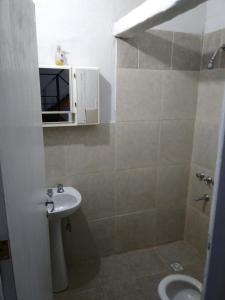 a bathroom with a sink and a toilet at Alojamiento Libertador in Alta Gracia +5 photos