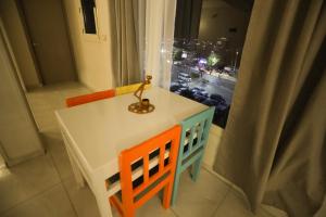a table and chairs with a view of a city at Pajama Hostel Nile View in Aswan