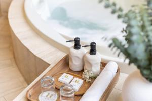 a table with two bottles of soap and a mirror at Hotel Park Suites Lima, Barranco in Lima