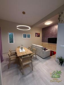 a living room with a table and a couch at Villa DAV'ANGEL in Le Lamentin