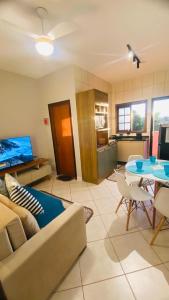 a living room with a couch and a table at Apartamento Ilha Comprida in Ilha Comprida