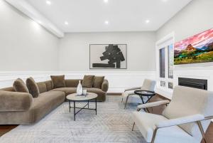 a living room with a couch and chairs and a fireplace at Welcome to Your Comfort Retreat by the Lake in Burlington