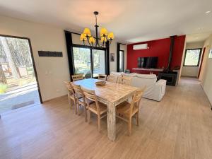 a dining room and living room with a table and chairs at Casa en Costa Esmeralda Descanso y Relax Premium 8 Pax in Costa Esmeralda