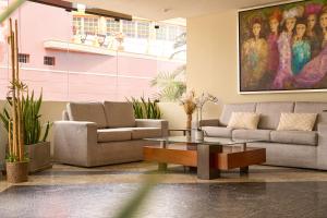 a living room with two couches and a coffee table at Hotel Park Suites in Lima
