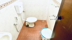 a bathroom with a toilet and a sink at Stay with Palee By Casa Paleo in Trivandrum +20 photos