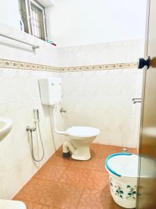 a bathroom with a toilet and a sink at Stay with Palee By Casa Paleo in Trivandrum