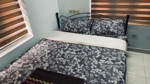 a bed with a black and white comforter and pillows at Stay with Palee By Casa Paleo in Trivandrum