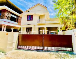 a house with a gate in front of it at Stay with Palee By Casa Paleo in Trivandrum
