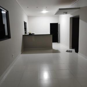 an empty room with white walls and white tile floors at Refúgio Urbano in Ji-Paraná
