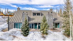a house with a gray roof in the snow at Eagles Roost Haven - Cozy Ski View Condo in Brian Head