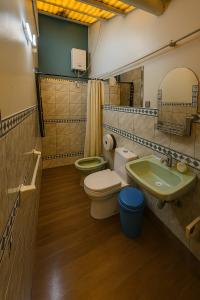 a bathroom with two toilets and a sink at Panay Golden in Cusco