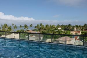 a view of the pool from the balcony of a resort at Apartment with incredible views, 10 meters from the beach in Porto De Galinhas