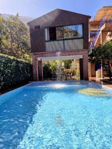 a swimming pool in front of a house at Top Ourika in Aghbalou