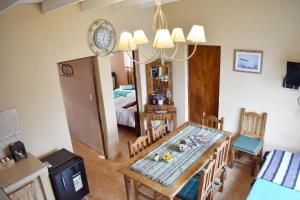 a dining room with a table and a mirror at Hotel Cabañas Aparts Tierra de Glaciares in El Calafate
