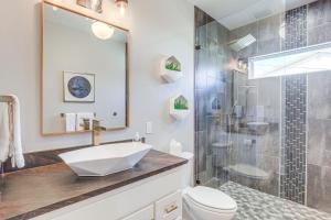 a bathroom with a sink and a shower at Walk to Shops and Winery! Stylish Dtwn Ovilla Home in Glenn Heights +16 photos