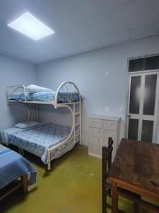 a room with two bunk beds and a table at Casa Ríos 
