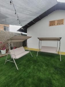 a patio with green grass and a table and a tent at Casa Ríos  +7 photos