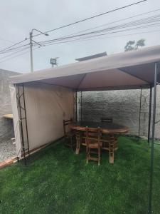 a tent with a table and chairs under it at Casa Ríos 