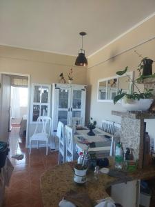 a kitchen and living room with a table and chairs at Beachfront apartment, exclusive view! in Xangri-lá