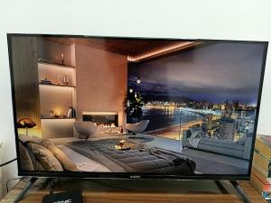 a large flat screen tv with a view of a city at Stylish Moroccan Apartment in Marrakesh