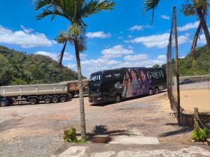 a large truck parked next to a palm tree at Balneário cascata chalés in Tianguá