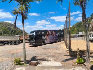 a bus parked in a parking lot next to a truck at Balneário cascata chalés in Tianguá