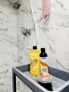 a shelf in a bathroom with two bottles of soap at Stylish Moroccan Apartment in Marrakesh +28 photos