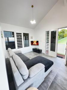 a living room with a couch and a fireplace at Villa Alizé Kreyol in Le François