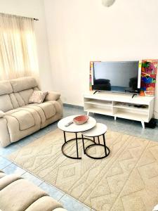 a living room with a couch and a coffee table at The Serenity Maisonnettes 2 in Kotu