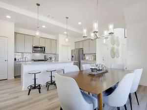 a kitchen and dining room with a table and chairs at Spacious 4BR Oasis - Pool - Patio - 8 Min to Kalahari in Round Rock