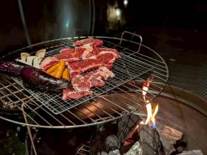 a group of meat and vegetables cooking on a grill at Frolic Field Nasu 源泉温泉の檜風呂 一棟貸切 BBQ ドッグラン 犬OK 9名 星空テラス in Nasu