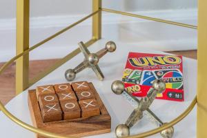 a glass table topped with a wooden box and two crossed candies at Heritage Haus - Luxe 2BR w Deck, Pets OK, Wi-fi, Near Marietta Sq in Marietta