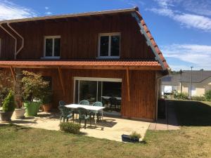 a house with a table and chairs in front of it at Gîte au Calme Proche de Nancy avec Terrasse Privative et Parking - FR-1-584-103 in Champenoux
