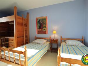 a bedroom with two beds and a bunk bed at Ferme XVIe siècle rénovée avec jardin clos et WiFi - FR-1-582-119 in Polignac