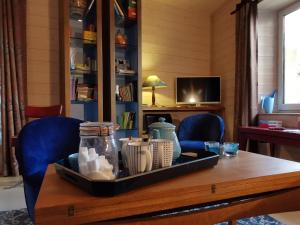 a table with a tray of items on top of it at Maison cosy avec cour privative au cœur de l'Auvergne - FR-1-582-316 in Lempdes sur Allagnon