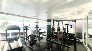 a gym with cardio equipment and a large window at Sunset Plaza Condominium in Karon Beach
