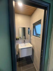 a bathroom with a sink and a mirror at The mountain Sea View in Vung Tau