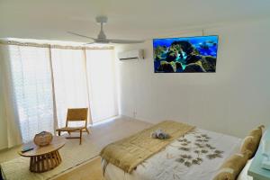 a bedroom with a bed and a table and a chair at Breathtaking view, comfort & ideal location in Saint Martin