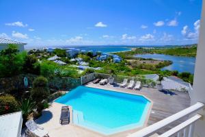a swimming pool on a balcony with a view of the water at Breathtaking view, comfort & ideal location in Saint Martin