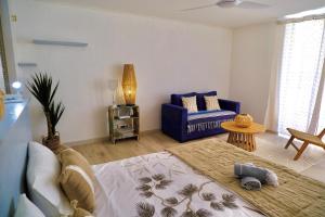 a living room with a blue couch and a table at Breathtaking view, comfort & ideal location in Saint Martin +23 photos